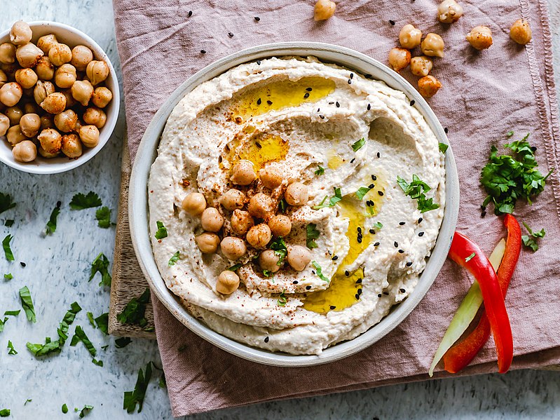 A picture of hummus, with chickpeas sitting on top